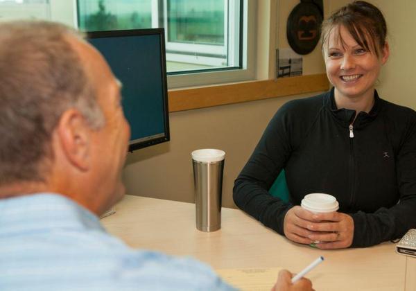 Male counsellor and female student talking in an office